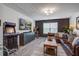Cozy living room with a large leather couch, entertainment center, and arcade game at 1901 Toland Ct, Johns Island, SC 29455