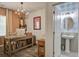 Home office with modern desk, stylish chandelier, and adjacent half bath at 1901 Toland Ct, Johns Island, SC 29455