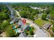 Aerial view of the house and neighborhood highlights the pool, nearby playgrounds, and mature tree cover at 2009 Terrabrook Ln, Charleston, SC 29412
