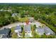 Lovely aerial view of the property featuring a pool, back deck, and mature trees at 2009 Terrabrook Ln, Charleston, SC 29412