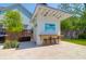 Outdoor kitchen bar offers seating for four, set in a travertine patio, with an outdoor shower and adjacent grill at 2009 Terrabrook Ln, Charleston, SC 29412