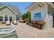 Inviting travertine patio by the pool has an outdoor bar and lounge seating, perfect for entertaining and relaxation at 2009 Terrabrook Ln, Charleston, SC 29412