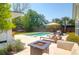 Backyard features a lovely in-ground pool, lounge chairs, a fire pit, a built-in bar, and outdoor seating at 2009 Terrabrook Ln, Charleston, SC 29412