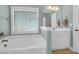 Bright bathroom features a large tub, vanity with sink, and a window for natural light at 2009 Terrabrook Ln, Charleston, SC 29412