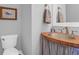Coastal half bath features a unique wood countertop and trough sink with updated fixtures at 2009 Terrabrook Ln, Charleston, SC 29412