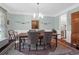 Traditional dining room featuring a wood table with upholstered chairs and a decorative rug at 2009 Terrabrook Ln, Charleston, SC 29412