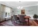 Dining room with a large rug, wood table, comfortable chairs, and a window providing natural light at 2009 Terrabrook Ln, Charleston, SC 29412