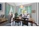 Light-filled dining room features a wooden table with seating for six and large windows with decorative curtains at 2009 Terrabrook Ln, Charleston, SC 29412
