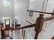 Bright foyer with wood floors and a staircase featuring dark wood railings and white balusters at 2009 Terrabrook Ln, Charleston, SC 29412