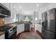 Modern kitchen featuring stainless steel appliances, granite countertops, and hardwood floors at 2009 Terrabrook Ln, Charleston, SC 29412