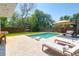 Inviting pool area with lounge chairs and an umbrella for relaxing on a sunny day at 2009 Terrabrook Ln, Charleston, SC 29412