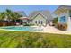 Backyard with an in-ground pool, patio with bar, lush green lawn, and inviting lounge furniture at 2009 Terrabrook Ln, Charleston, SC 29412