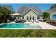 Beautiful backyard pool with sun loungers surrounded by lush greenery and an outdoor dining area at 2009 Terrabrook Ln, Charleston, SC 29412