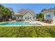 Inviting backyard with a sparkling pool, lush lawn, and comfortable lounge area at 2009 Terrabrook Ln, Charleston, SC 29412