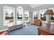 Bright sunroom with lots of natural light, bench seating, and a view of the outdoor pool at 2009 Terrabrook Ln, Charleston, SC 29412