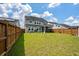 Fenced backyard featuring a lush lawn, mature trees, and plenty of space for outdoor activities at 206 Evergreen Ave, Summerville, SC 29485