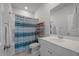 Bathroom with white vanity, striped shower curtain, and tile flooring at 206 Evergreen Ave, Summerville, SC 29485