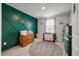 Charming Bedroom featuring a stylish green accent wall and ample natural light at 206 Evergreen Ave, Summerville, SC 29485