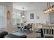 Dining room features modern light fixture, wood table, rug, and neutral colors at 206 Evergreen Ave, Summerville, SC 29485