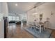Open-concept dining and living space featuring wood floors and modern light fixtures at 206 Evergreen Ave, Summerville, SC 29485