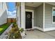 Close-up of the front door with a decorative wreath and potted flowers on a sunny porch at 206 Evergreen Ave, Summerville, SC 29485