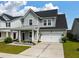 Charming two-story home with a metal roof and a well-manicured front yard with an attached garage at 206 Evergreen Ave, Summerville, SC 29485