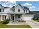 Charming two-story home with a metal roof, a covered porch and a well-manicured front yard at 206 Evergreen Ave, Summerville, SC 29485