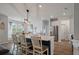 Open kitchen with center island, bar stool seating, stainless refrigerator, and adjacent dining area at 206 Evergreen Ave, Summerville, SC 29485
