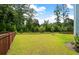 The backyard is flat, grassy, and fenced at 208 Cherry Grove Dr, Summerville, SC 29483
