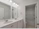 Bathroom featuring double sinks, a large mirror, and a shower-tub combination at 208 Cherry Grove Dr, Summerville, SC 29483