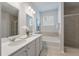 Bright bathroom with a double sink vanity, soaking tub, and a glass shower enclosure at 208 Cherry Grove Dr, Summerville, SC 29483