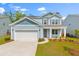 Charming two-story home with a well-manicured lawn and attached two-car garage at 208 Cherry Grove Dr, Summerville, SC 29483
