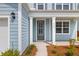 Charming front porch featuring an entry door, complemented by manicured landscaping at 208 Cherry Grove Dr, Summerville, SC 29483