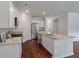 Open concept kitchen includes granite countertops, stainless appliances, large center island, and hardwood floors at 208 Cherry Grove Dr, Summerville, SC 29483