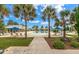 Tranquil pool area with palm trees, lounge chairs, and covered cabanas, offering a resort-like experience at 208 Cherry Grove Dr, Summerville, SC 29483