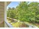 Relaxing balcony view overlooking mature trees and a well-manicured lawn, providing a private retreat at 2096 Promenade Ct, Mount Pleasant, SC 29466