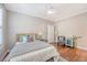Bright bedroom featuring hardwood floors, a ceiling fan, and views of the exterior at 2096 Promenade Ct, Mount Pleasant, SC 29466