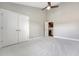Bright bedroom showcasing neutral tones, plush carpeting, ceiling fan, and a double door closet at 2096 Promenade Ct, Mount Pleasant, SC 29466