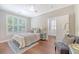 Cozy bedroom with a ceiling fan, shuttered windows, and hardwood floors at 2096 Promenade Ct, Mount Pleasant, SC 29466