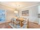 Dining area features a wood table, chandelier, and a beach-themed painting on the wall at 2096 Promenade Ct, Mount Pleasant, SC 29466