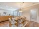 Bright dining area features a wood table, wood floors, and natural light from an adjacent room and door at 2096 Promenade Ct, Mount Pleasant, SC 29466