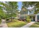 Townhome exterior featuring a well-kept lawn, mature trees, and a welcoming walkway at 2096 Promenade Ct, Mount Pleasant, SC 29466