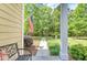 Inviting front porch with decorative foliage, a bench, and a walkway view at 2096 Promenade Ct, Mount Pleasant, SC 29466