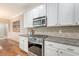 Elegant kitchen with white cabinets, granite counters, and stainless steel appliances at 2096 Promenade Ct, Mount Pleasant, SC 29466