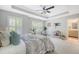 Spacious bedroom featuring a tray ceiling, ceiling fan, and access to the exterior and bathroom at 2096 Promenade Ct, Mount Pleasant, SC 29466