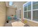 Relaxing patio area with seating, a colorful rug and flowers, accessed through charming double doors, perfect for enjoying the outdoors at 2096 Promenade Ct, Mount Pleasant, SC 29466