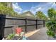 Private patio area with comfortable seating, lush greenery, and a dark privacy fence creating a peaceful outdoor living space at 2096 Promenade Ct, Mount Pleasant, SC 29466