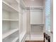 Bright walk-in closet with custom white shelving and hanging rods for optimal storage and organization at 2096 Promenade Ct, Mount Pleasant, SC 29466