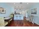 Dining area showcasing hardwood floors and a breakfast bar leading into the well-lit kitchen at 2134 Landfall Way, Seabrook Island, SC 29455
