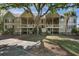 Two story condo building with dual entry points with front yard featuring a large tree and palm tree at 2134 Landfall Way, Seabrook Island, SC 29455